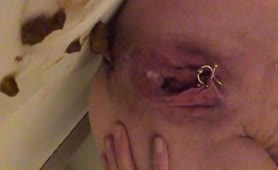 Pierced babe shitting