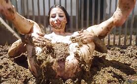 Nude Woman Rolls and Smears Herself in a Manure Pit