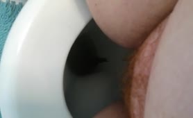 Close up of fat redhead shitting