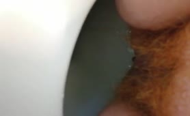 Close up of hairy babe shitting