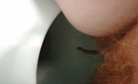 Hairy babe shits over toilet