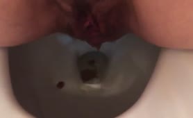 Hairy babe shits over toilet