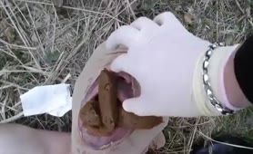 She feeds male slave with a lot of shit