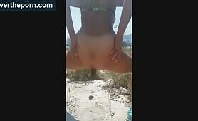 Tanned hot babe poops on the rock 