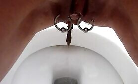 Pierced pussy lady pooping closeup 