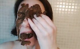Eating dark shit and smearing it all over her face 