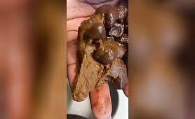 Ebony lady pushing pebbles into the toilet